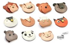 small animal shaped leather coin purses with buttons on the front and back, all in different colors