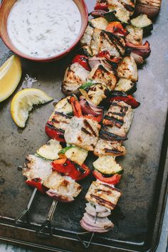 grilled meat and vegetables on skewers with dipping sauce