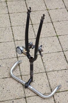 there is a bike stand on the ground with it's handlebars down