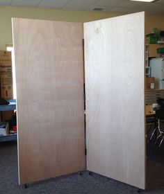 a room divider made out of plywood boards in an office cubicle area