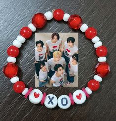 an xo beaded photo frame with red and white beads around it on a table