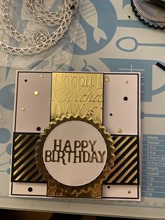 a close up of a happy birthday card on top of a table with other items