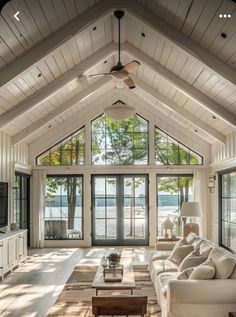 a living room filled with furniture and windows