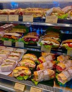 a display case filled with lots of different types of sandwiches