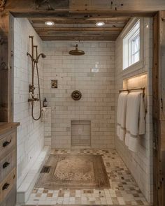 a large bathroom with white tile and wood trimmings on the walls, along with an open shower