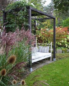 a white bench sitting in the middle of a garden