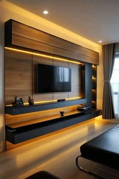 modern living room with black furniture and white lights on the tv stand, built into the wall