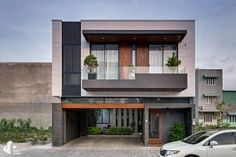 a car is parked in front of a modern house