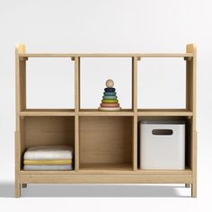 a wooden shelf with two bins and a toy on top