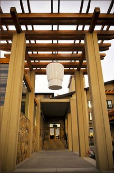 a tall wooden structure with a white lantern hanging from it's side