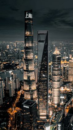 an aerial view of skyscrapers in the city at night