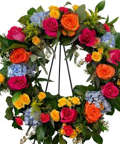 a colorful wreath with flowers and greenery