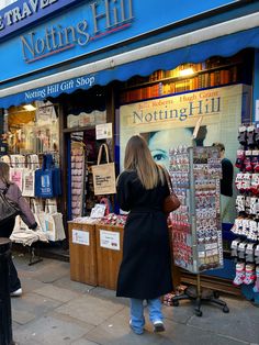 people are walking past a notting hill shop