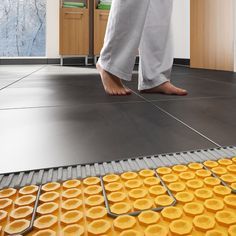 a person walking across a kitchen floor covered in yellow circles