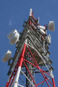 the top of a cell phone tower against a blue sky