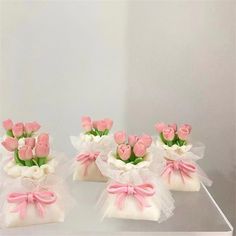 pink and white flowers are in small bags