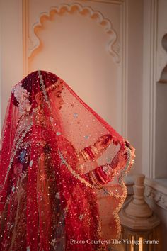 a woman in red and gold bridal gown