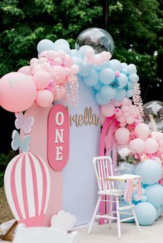 an outdoor birthday party with balloons and decorations