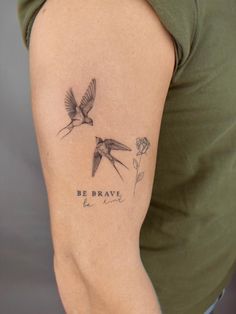 a woman's arm with two birds and the words be brave tattooed on it