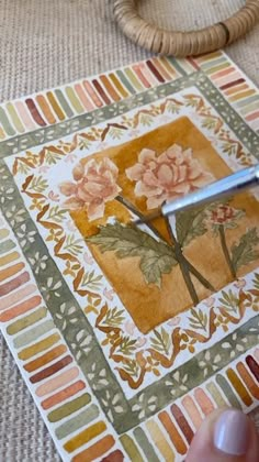 someone is using scissors to cut the flowers on a quilted square with strips of fabric