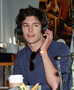 a man wearing headphones while sitting at a table