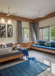 a living room filled with furniture and lots of windows