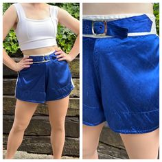 An adorable pair of 1960s blue satin gym shorts, featuring a functional belt buckle at the waist. They have flared legs and a fitted high waist. They zip up the back and button at the waist. I've washed these shorts, and they are ready to wear!  They are in good vintage condition. The last photo block shows a few scattered pick holes. There are tiny scuffs throughout the satin.  The white top is not included.  Measurements  Waist: snug 32 inches (the belt can tighten to 31 inches)  Hips: up to 44 inches  Total length: 13.5 inches  Rise: 11 inches  From a smoke and pet free home. I ship Monday, Wednesday, and Friday. I do not offer returns, so please reach out with any questions or to ask for additional photos/measurements. Vintage Blue Shorts With Belt Loops, Fitted Retro Blue Shorts, Vintage Fitted Blue Shorts, Fitted Vintage Blue Shorts, 1950s Shorts, 50s Women, Baton Twirling, Shorts With Belt, Satin Shorts