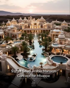 an aerial view of a large mansion in the middle of palm trees and water at dusk