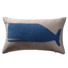 a pillow with a blue whale on it