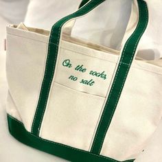 a tote bag with embroidered words on it