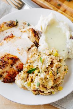 a white plate topped with chicken and mashed potatoes