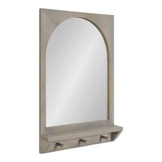 a wooden mirror and shelf with an arched mirror above it on a white wall background