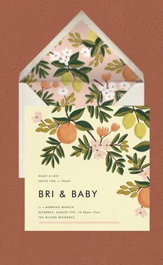 an envelope with the words bri and baby printed on it, in front of a peach - colored background