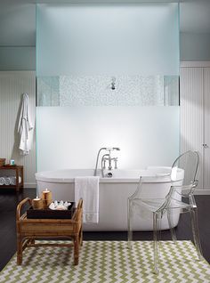 a white bath tub sitting on top of a wooden floor