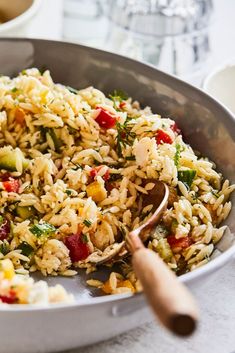 a bowl filled with rice and vegetables on top of a table