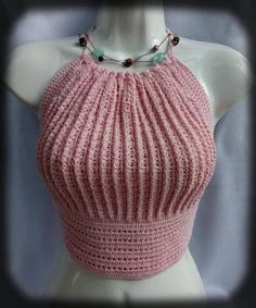 a mannequin wearing a pink knitted top