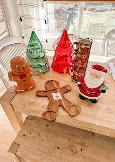 a wooden table topped with christmas decorations and gingerbread man cut out on top of it