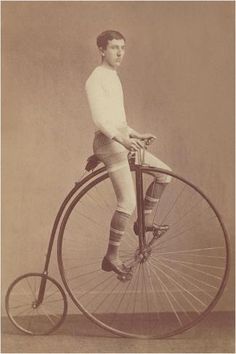 an old time photo of a man sitting on top of a penny - wheel bicycle