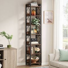 a living room filled with furniture and a tall book shelf next to a window on top of a hard wood floor