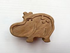 a wooden elephant brooch sitting on top of a table