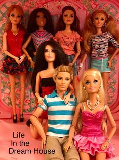 a group of barbie dolls sitting next to each other in front of a pink background