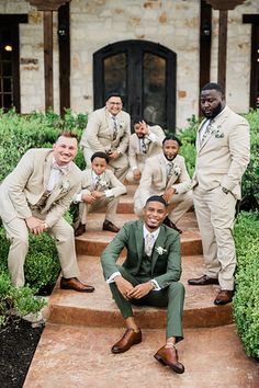 a group of men in suits and ties posing on steps