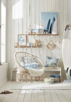 a white room with a surfboard and other items on the shelves in front of it