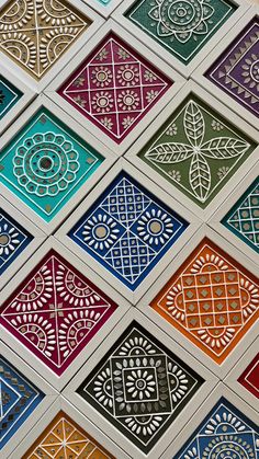 many different colored tiles with designs on them