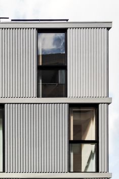 an apartment building with multiple windows on the side