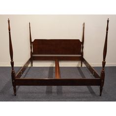 an antique wooden bed frame with two posts