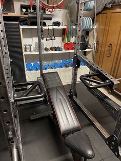 a bench and weight machine in a home gym