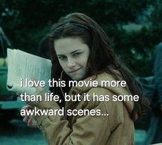 a girl is holding a book and looking at the camera with a smile on her face that says i love this movie more than life, but it has some awkward awkward