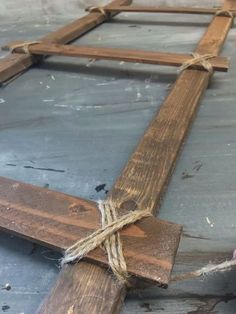 a wooden cross with rope tied around it