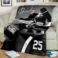 an ice hockey themed throw blanket with the name brady on it and two pairs of shoes